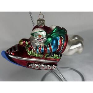 Vintage Christmas ornament hand-blown Santa riding on a snowmobile